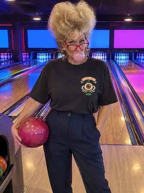 Deborah wearing the Please Hold Tee